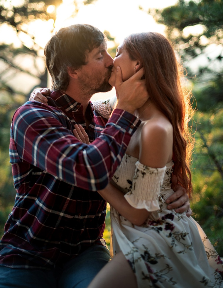 A man and a woman kiss during their Virginia engagement photography session