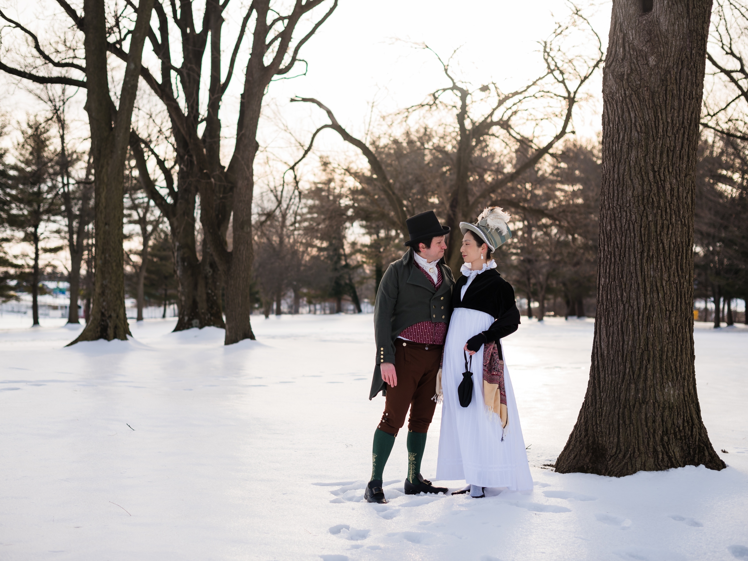 A historical costuming couple poses together on a snowy afternoon at Rose Hill Manor Park in Frederick, Maryland